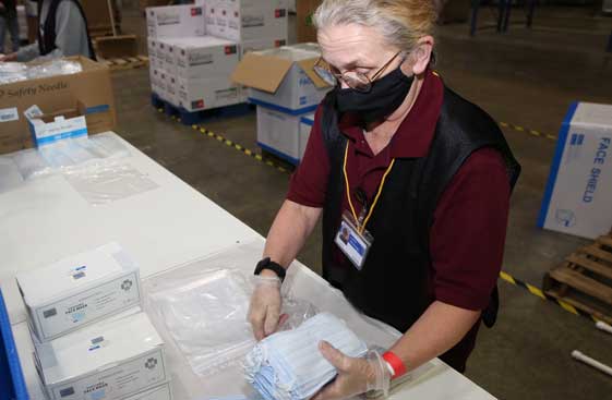 Employee assembling a pharmaceutical kit