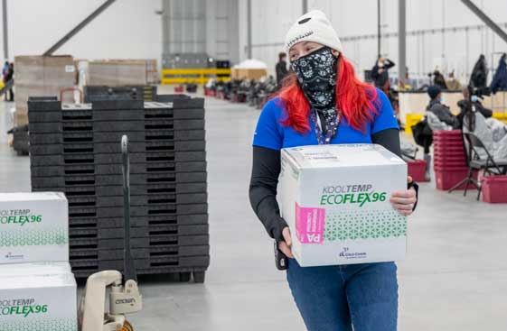 Warehouse employee carrying a box