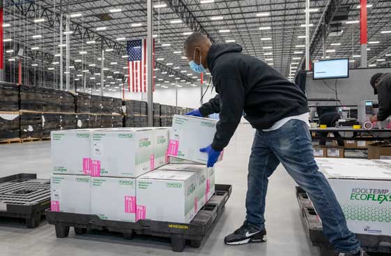 Warehouse worker fills a pallet with boxes of Moderna vaccines<br>  <p>&nbsp;</p>  
