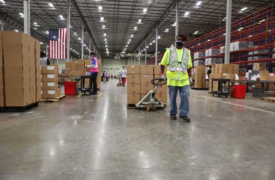 Warehouse employee pulling a pallet through the warehouse