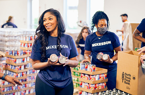 McKesson warehouse workers packing boxes for a food bank