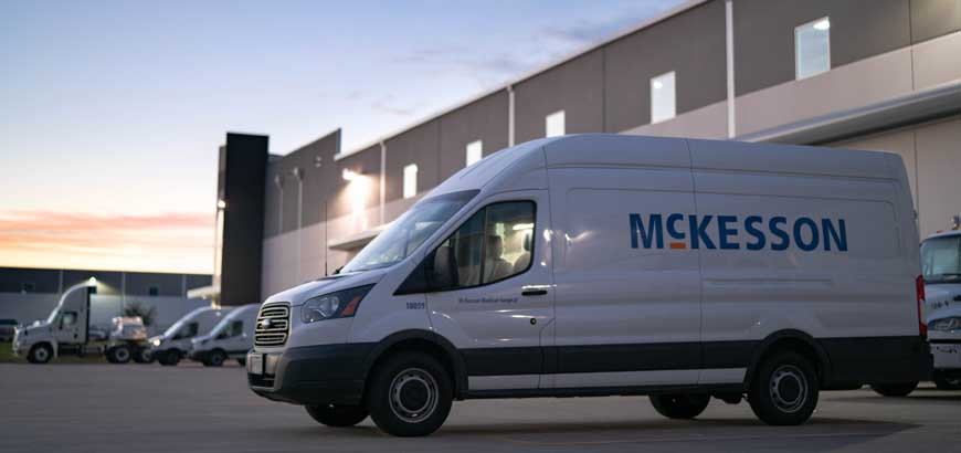 A McKesson delivery van parked in front of a distribution center