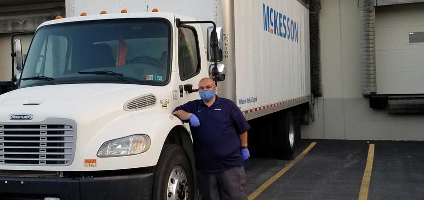 A man standing next to a McKesson truck