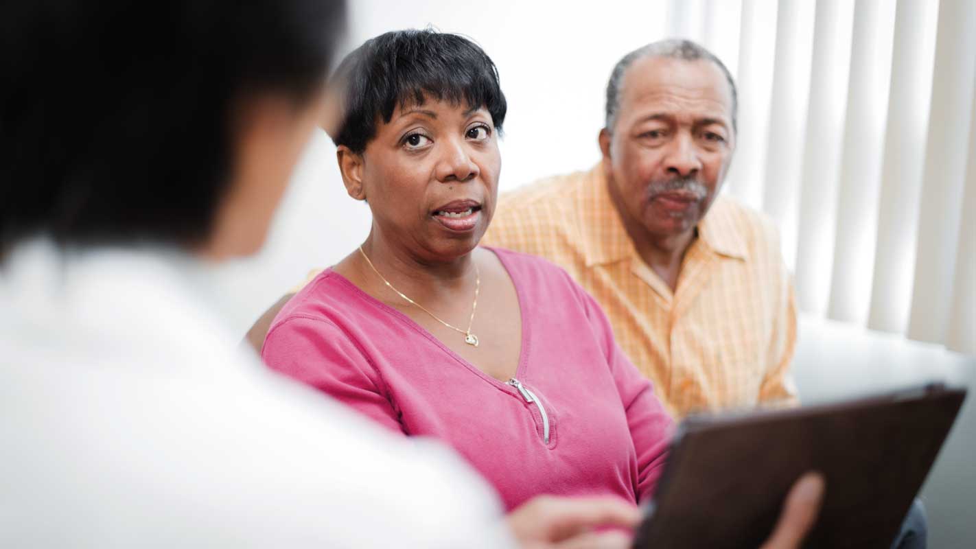 A doctor consulting with two patients