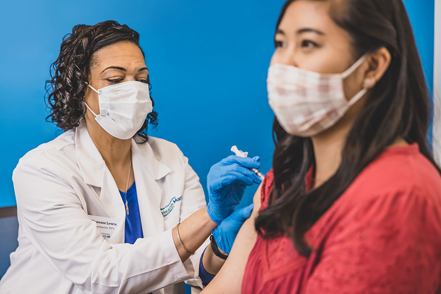 HealthMart pharmacist injecting vaccine into patient